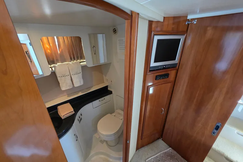 Aloha Spirit Yacht Photos Pics Luxurious bathroom in 2005 Carver 41 Cockpit Motor Yacht with wood accents and modern amenities.