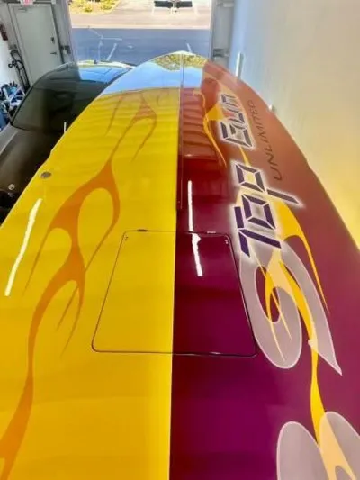 On Your Mark Yacht Photos Pics 2005 Cigarette 39 Top Gun boat with vibrant yellow and red flame design.