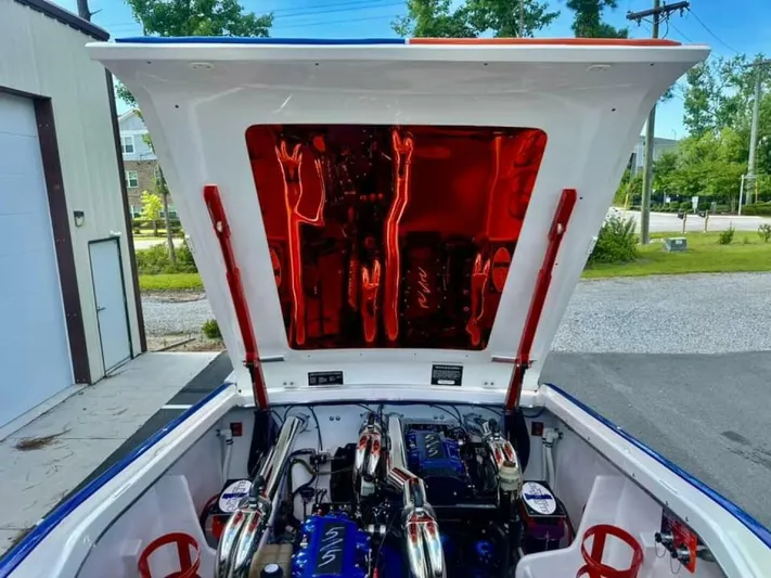 On Your Mark Yacht Photos Pics 2005 Cigarette 39 Top Gun boat engine compartment with open hatch, showcasing powerful engines.