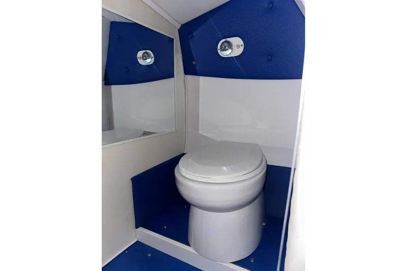 On Your Mark Yacht Photos Pics 2005 Cigarette 39 Top Gun Unlimited boat bathroom with blue and white interior design.