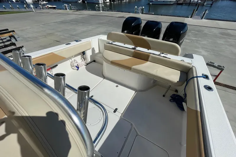  Yacht Photos Pics 2007 Fountain 34 Center Console boat interior with seating and rod holders at marina.