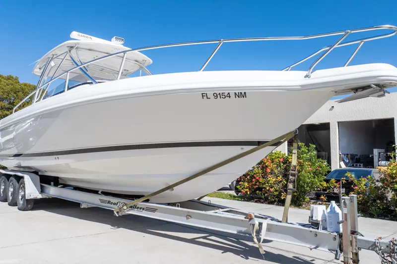  Yacht Photos Pics 2007 Intrepid 350 WA boat on trailer, parked outdoors under clear blue sky.