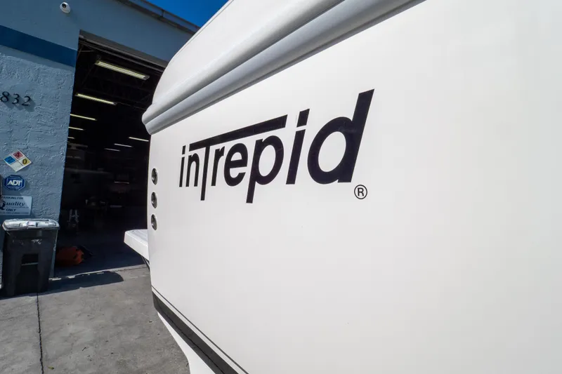  Yacht Photos Pics 2007 Intrepid 350 WA boat logo on white hull near a garage entrance.