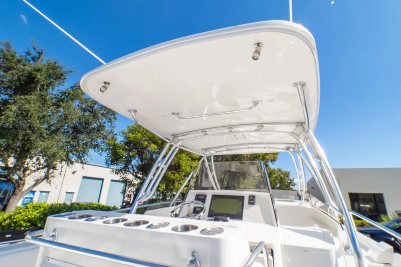  Yacht Photos Pics 2007 Intrepid 350 WA boat cockpit with canopy, steering console, and clear blue sky.