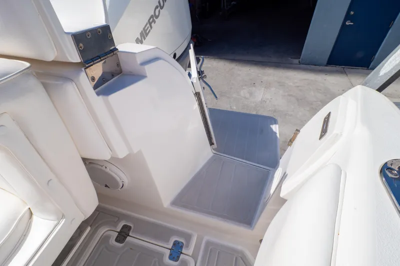  Yacht Photos Pics 2007 Intrepid 350 WA boat interior with Mercury engine, featuring white seating and deck.