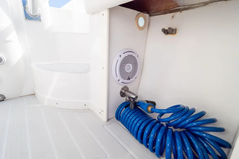  Yacht Photos Pics 2007 Intrepid 350 WA boat interior with coiled blue hose and speaker.
