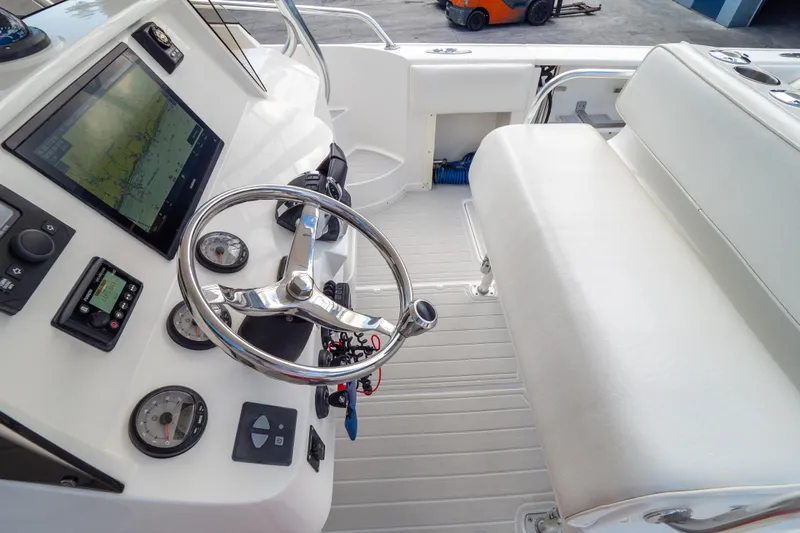  Yacht Photos Pics 2007 Intrepid 350 WA boat cockpit with steering wheel and navigation instruments.