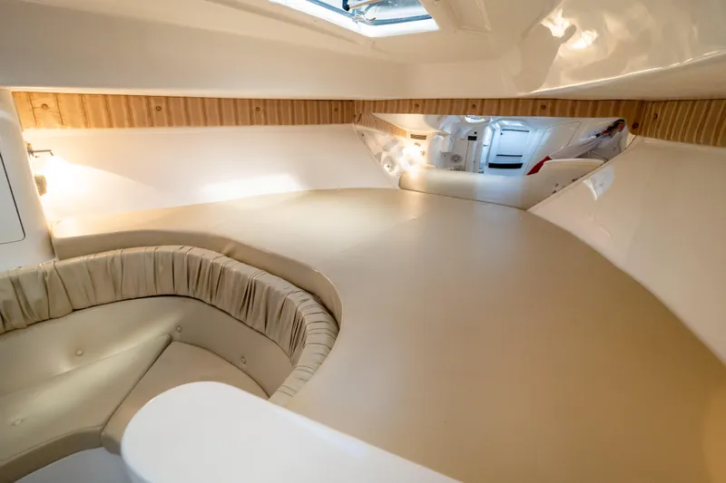  Yacht Photos Pics Interior cabin of 2007 Intrepid 350 WA boat with beige seating and wood accents.