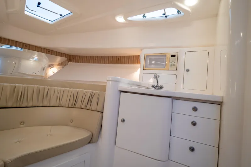  Yacht Photos Pics 2007 Intrepid 350 WA cabin interior with kitchenette, microwave, and seating area.