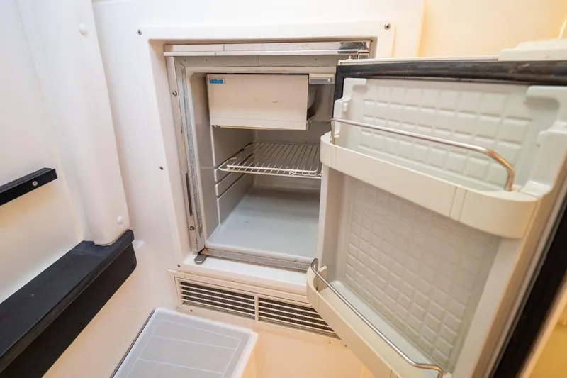  Yacht Photos Pics Open refrigerator inside a 2007 Intrepid 350 WA boat, showing interior shelves.