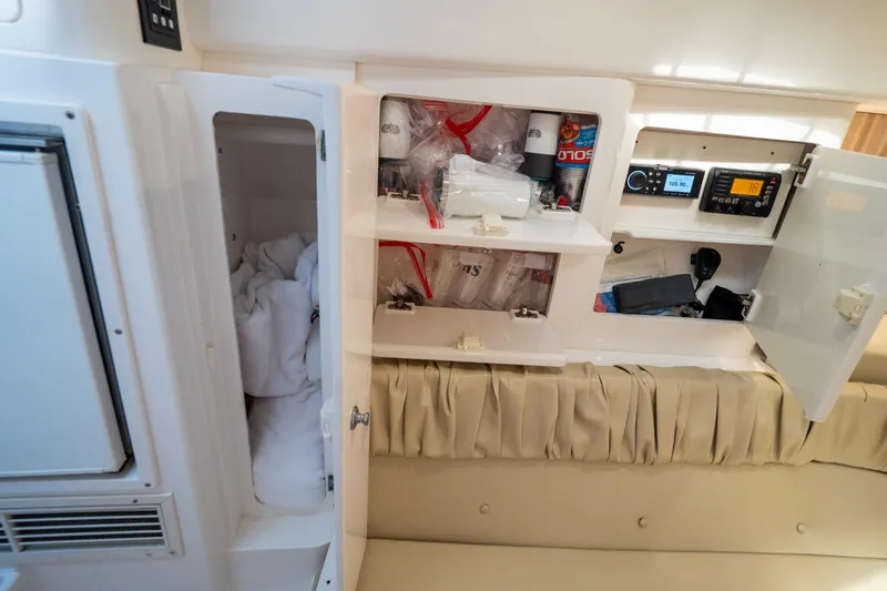  Yacht Photos Pics Interior of a 2007 Intrepid 350 WA boat showing open storage compartments and electronic equipment.