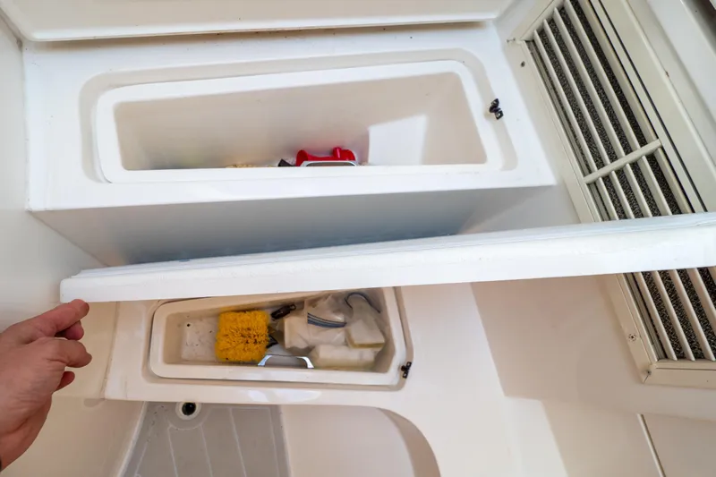  Yacht Photos Pics Storage compartments on a 2007 Intrepid 350 WA boat, containing cleaning supplies.