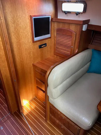 Limbo Yacht Photos Pics Interior of 2010 Sabre 40 Sedan with wood paneling and beige seating.