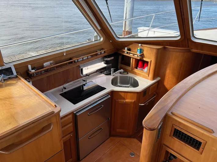 Limbo Yacht Photos Pics 2010 Sabre 40 Sedan yacht interior with modern kitchen and wooden cabinetry.