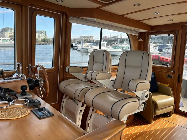 Limbo Yacht Photos Pics Interior of 2010 Sabre 40 Sedan yacht with luxurious seating and waterfront view.