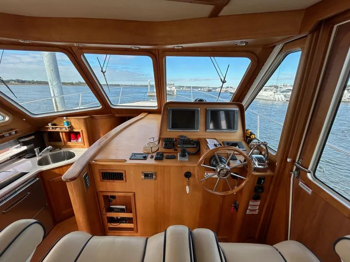 Limbo Yacht Photos Pics Interior of 2010 Sabre 40 Sedan yacht with helm, steering wheel, and navigation screens.