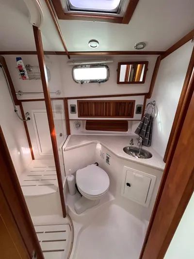 Limbo Yacht Photos Pics 2010 Sabre 40 Sedan yacht bathroom with modern fixtures and wood accents.