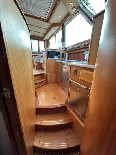 Limbo Yacht Photos Pics Interior of 2010 Sabre 40 Sedan yacht with wooden cabinetry and modern appliances.