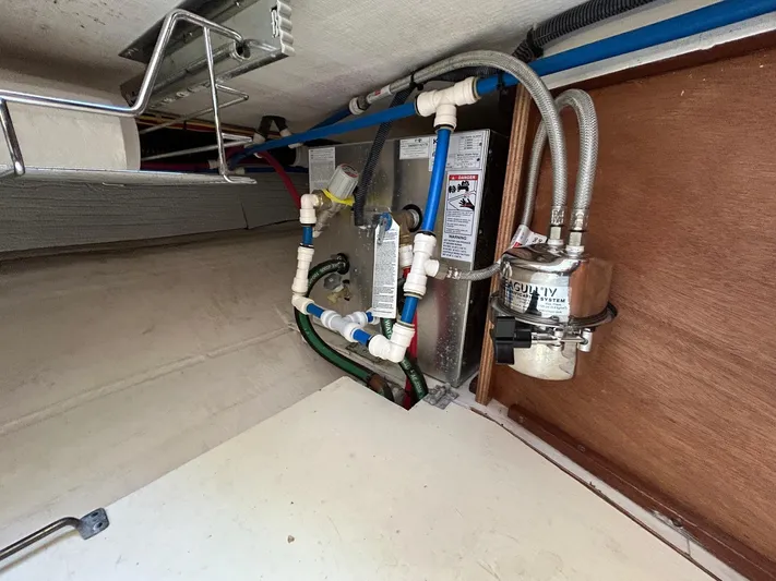 Limbo Yacht Photos Pics 2010 Sabre 40 Sedan plumbing system with pipes and fittings in a compartment.