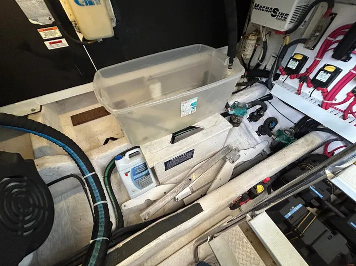 Limbo Yacht Photos Pics Engine room of a 2010 Sabre 40 Sedan with various equipment and storage containers.