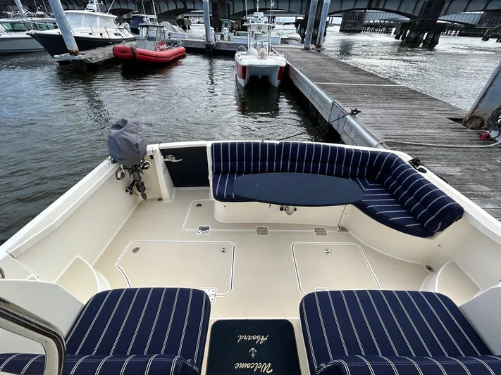 Limbo Yacht Photos Pics 2010 Sabre 40 Sedan boat with striped seating at a marina dock.