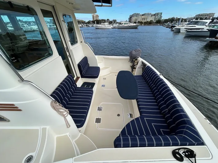 Limbo Yacht Photos Pics 2010 Sabre 40 Sedan boat with striped seating, docked in a marina.