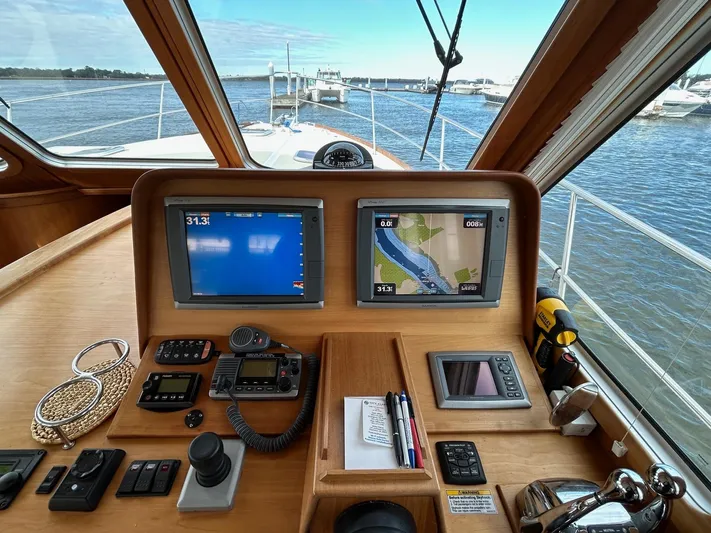 Limbo Yacht Photos Pics 2010 Sabre 40 Sedan helm with navigation screens and controls, overlooking marina.