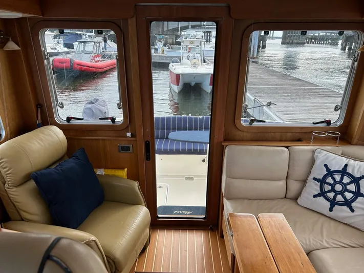 Limbo Yacht Photos Pics Interior of 2010 Sabre 40 Sedan yacht with comfortable seating and marina view.