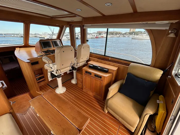 Limbo Yacht Photos Pics Interior of 2010 Sabre 40 Sedan yacht with wooden finish and waterfront view.