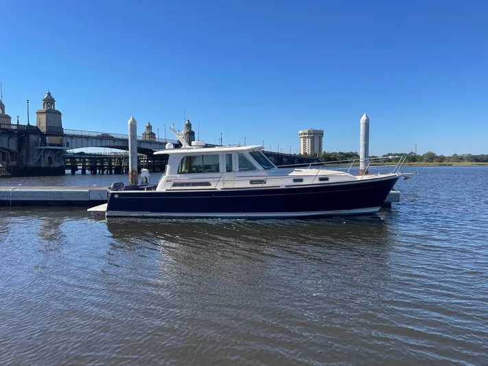 Limbo Yacht Photos Pics 2010 Sabre 40 Sedan yacht docked by a scenic waterfront.