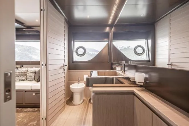  Yacht Photos Pics Luxurious bathroom interior of 2020 Riva 90 Argo yacht with modern fixtures and wood accents.