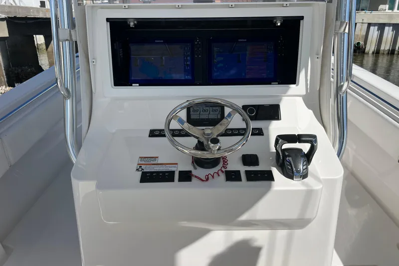  Yacht Photos Pics 2023 Contender 39 ST boat dashboard with steering wheel and dual displays.