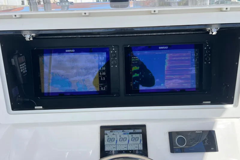  Yacht Photos Pics 2023 Contender 39 ST boat dashboard with dual Simrad displays and navigation controls.