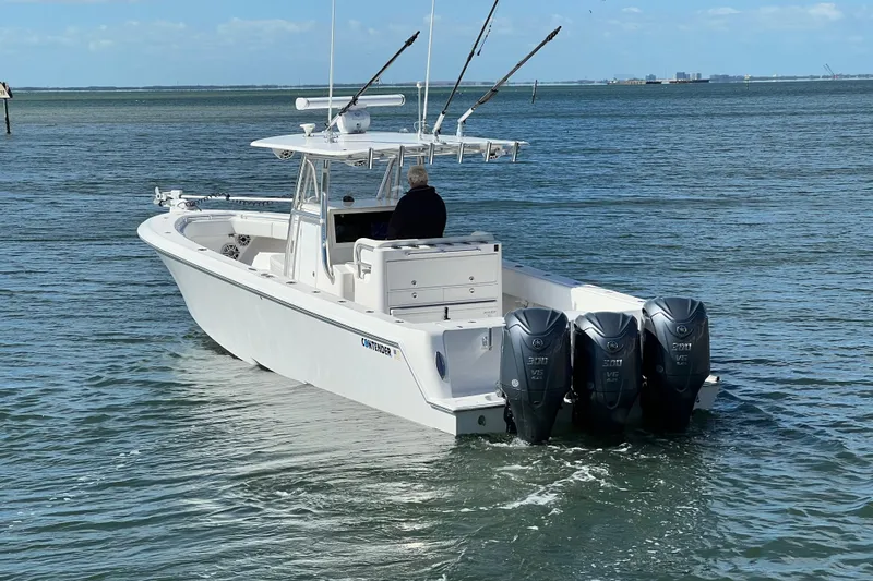 Yacht Photos Pics 2023 Contender 39 ST boat with triple outboard engines on open water.