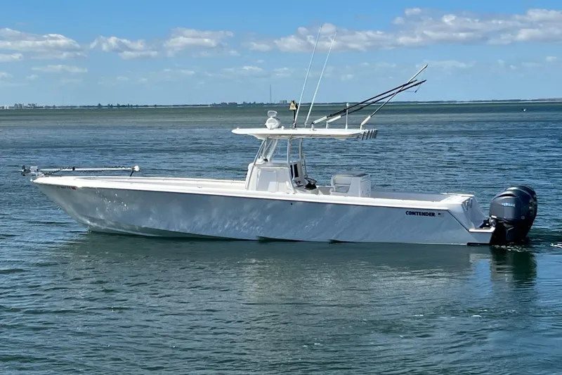  Yacht Photos Pics 2023 Contender 39 ST boat on calm water under a clear blue sky.