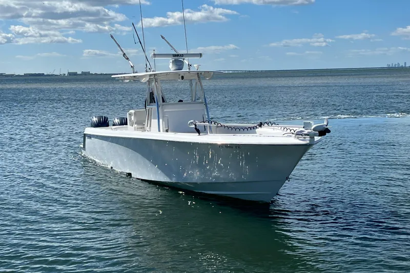  Yacht Photos Pics 2023 Contender 39 ST boat on calm water under blue sky.