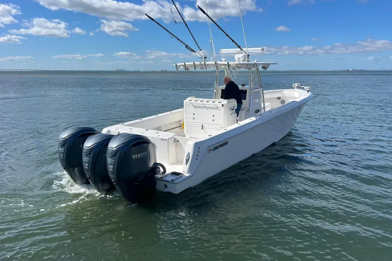  Yacht Photos Pics 2023 Contender 39 ST boat with triple Yamaha engines on open water.
