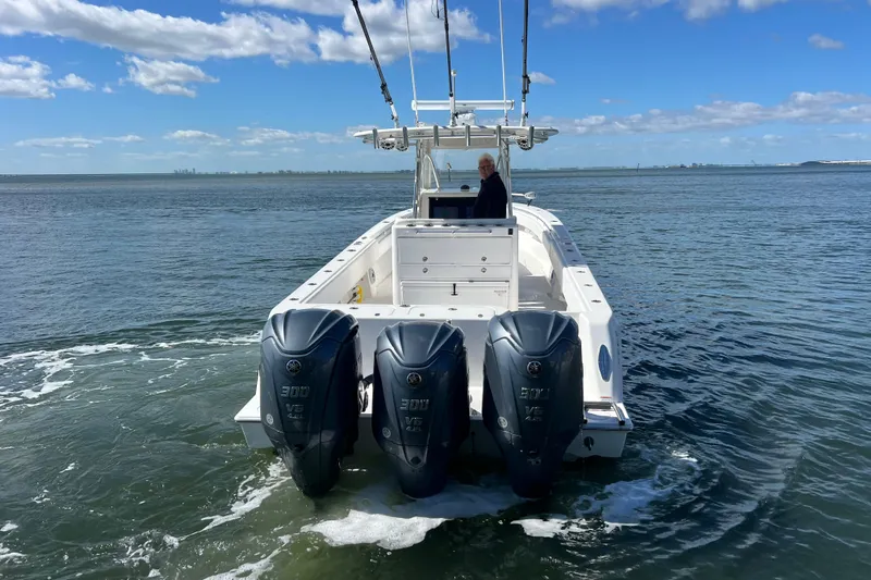  Yacht Photos Pics 2023 Contender 39 ST boat with triple outboard engines on open water.