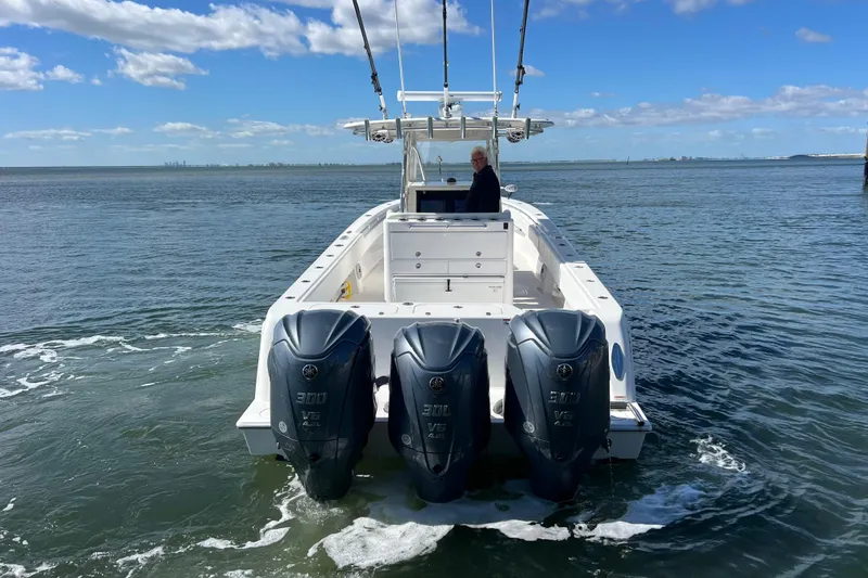 Yacht Photos Pics 2023 Contender 39 ST boat with triple Yamaha engines on open water.