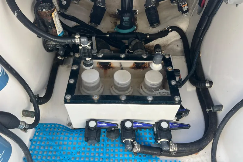  Yacht Photos Pics Engine compartment of 2023 Contender 39 ST boat with visible filters and hoses.