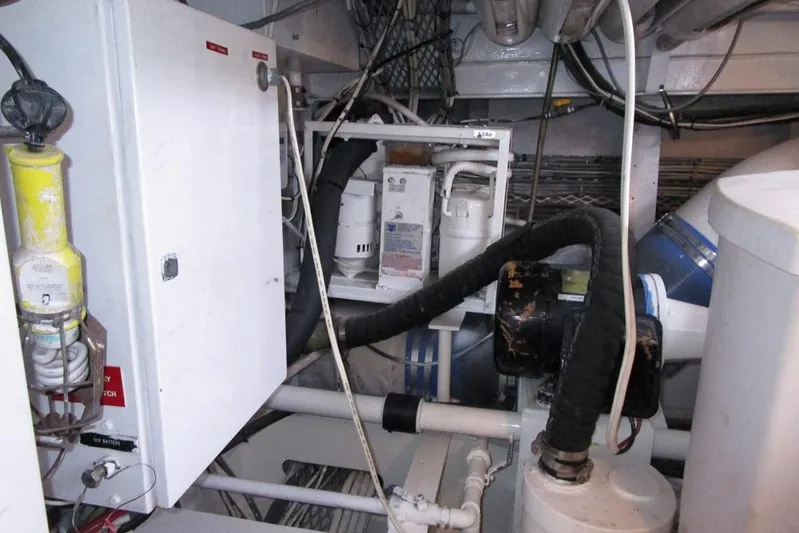 Elska Yacht Photos Pics Engine room of 1989 Striker 62 yacht with various mechanical components and wiring.