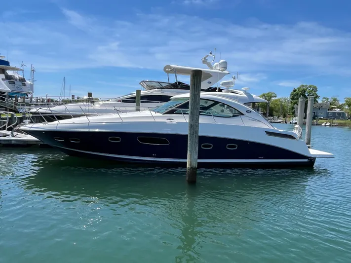 Feeling Nauti Yacht Photos Pics 2011 Sea Ray 470 Sundancer yacht docked in a marina under a clear blue sky.