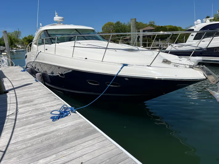 Feeling Nauti Yacht Photos Pics 2011 Sea Ray 470 Sundancer yacht docked at marina under clear blue sky.