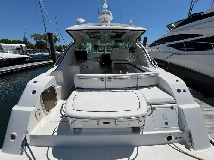 Feeling Nauti Yacht Photos Pics 2011 Sea Ray 470 Sundancer yacht docked, showcasing spacious rear seating and sleek design.