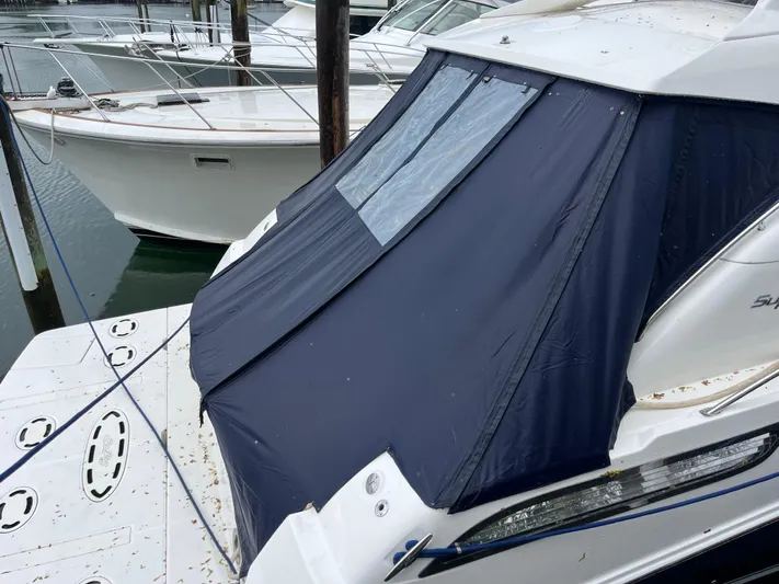 Feeling Nauti Yacht Photos Pics 2011 Sea Ray 470 Sundancer yacht with blue canvas cover at marina.