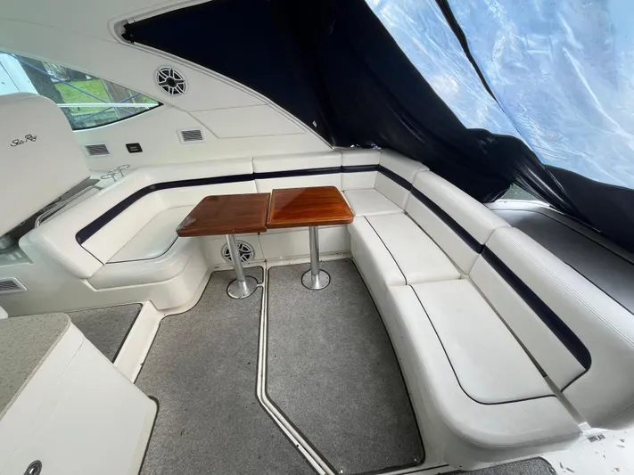 Feeling Nauti Yacht Photos Pics Luxurious interior of 2011 Sea Ray 470 Sundancer with white seating and wooden tables.