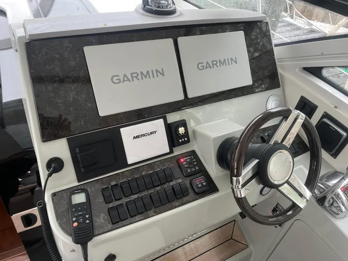 Feeling Nauti Yacht Photos Pics Helm of 2011 Sea Ray 470 Sundancer with Garmin displays and Mercury controls.