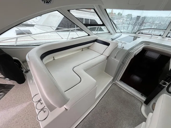 Feeling Nauti Yacht Photos Pics 2011 Sea Ray 470 Sundancer interior with white seating and large windows.