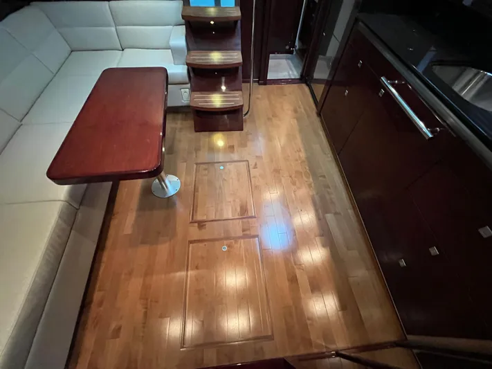 Feeling Nauti Yacht Photos Pics Interior of 2011 Sea Ray 470 Sundancer with wooden flooring and seating area.