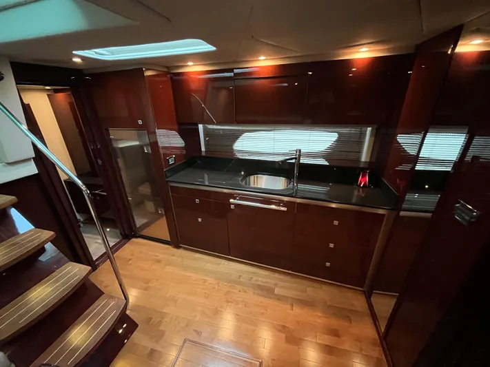 Feeling Nauti Yacht Photos Pics Luxurious kitchen interior of 2011 Sea Ray 470 Sundancer yacht with wood flooring and modern cabinetry.